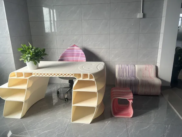 Printed desk and stools in a showroom